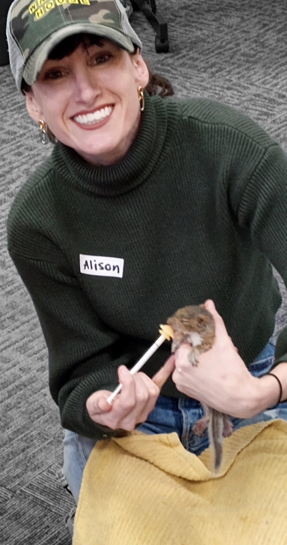 Alison Vickers is feeding squirrel baby.jpg